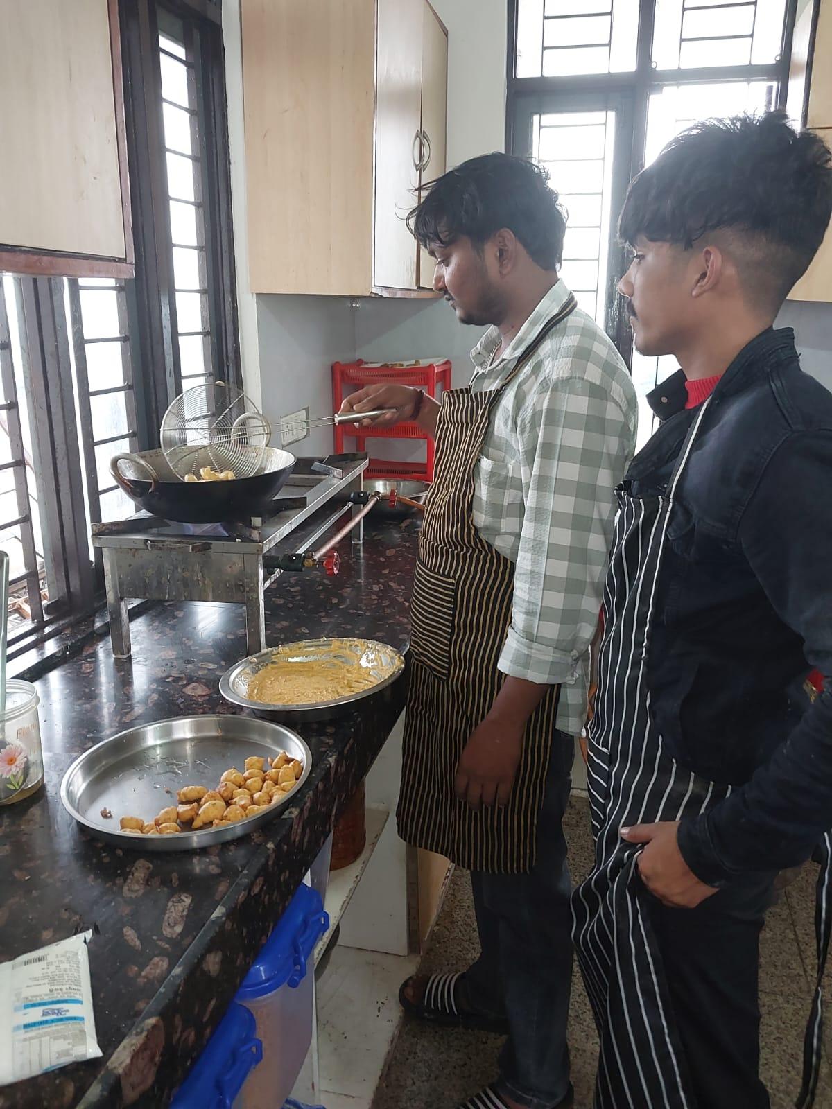 Hygienic in-house kitchen staff preparing fresh snacks for residents