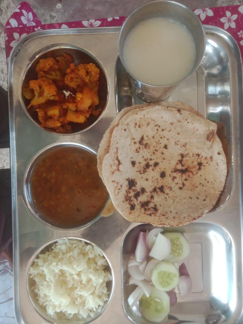 Home-style lunch thali with roti, dal and rice for PG residents